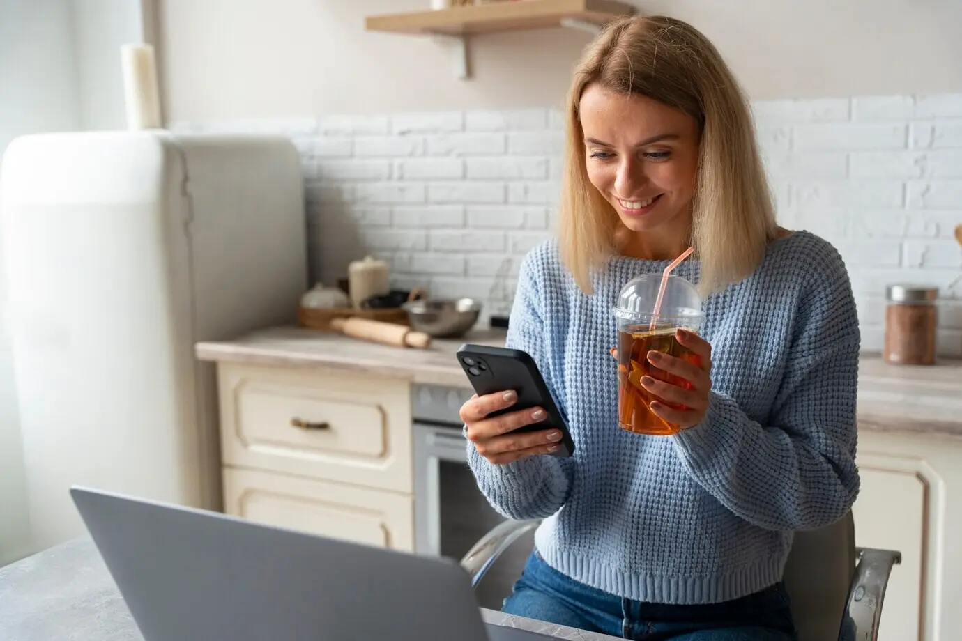 Medium shot of a woman holding a smartphone